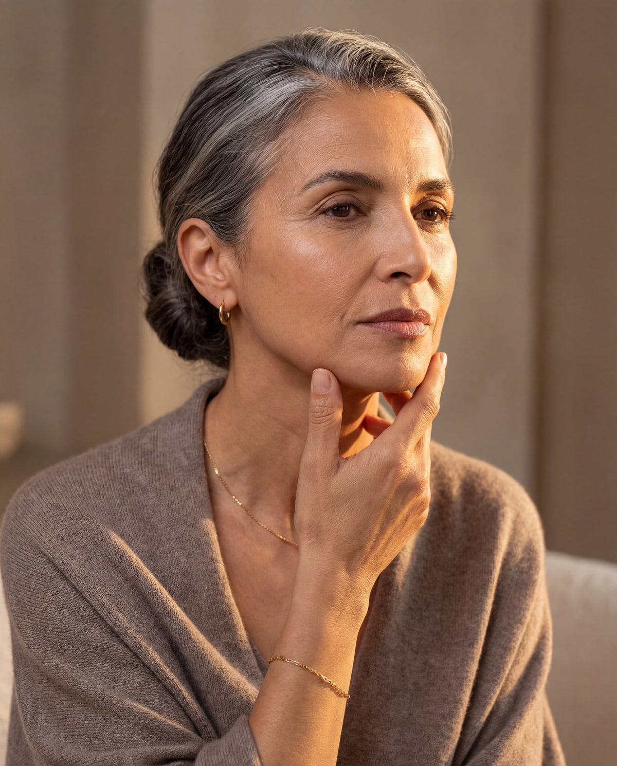 Woman 50 years old examines the firmness of her jaw — PDRN collagen anti-aging mask without injection